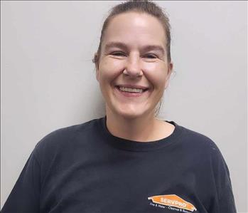 Female employee in front of white wall